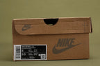 Air Max 1 Cactus Jack Wheat Lemon Drop DO9392-701 - Toe Box Close Up on Olive Background Showing Wheat Smooth Leather Toe Box Lemon Drop Large-Grid Waffle Mesh Quarter Panel and Red Polka Dot Rope Laces