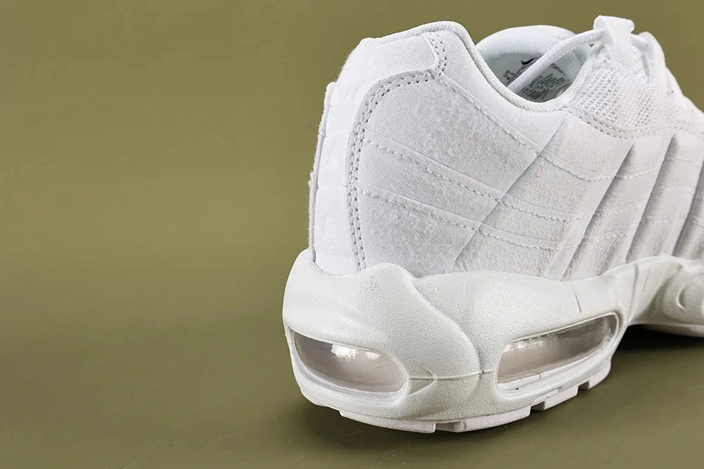 Air Max 95 Triple White Men's - Pair Three Quarter View on Olive Background