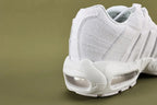 Air Max 95 Triple White Men's - Pair Three Quarter View on Olive Background