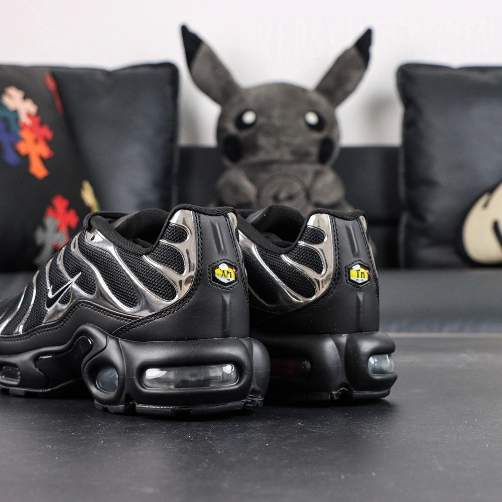 Air Max Plus SE Black Chrome Silver 2024 - Heel Pair Rear View with Yellow Tn Air Badge and Pikachu on Sofa