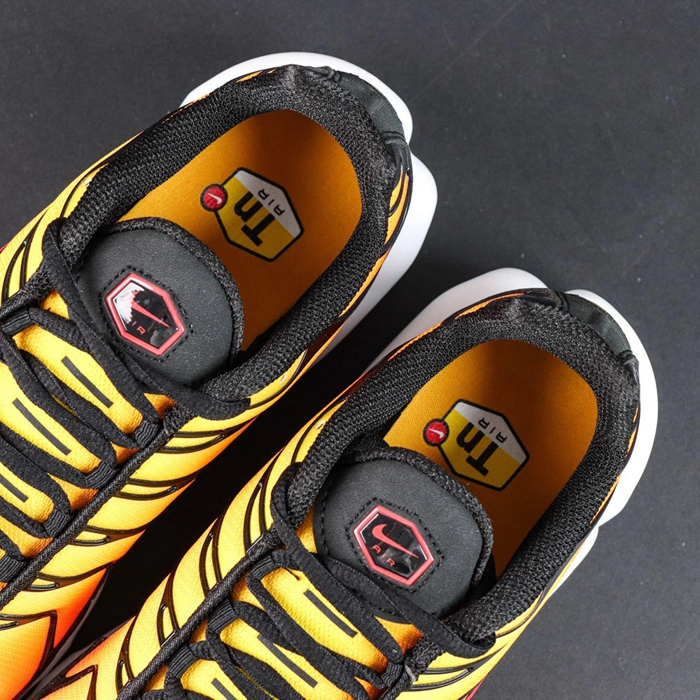 Air Max Plus Sunset 2024 - Pair Top Down View on Dark Background Showing Full Gradient Upper and Red Swoosh