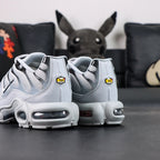 Air Max Plus TN Wolf Grey 2018 - Toe Box Close Up Detail Showing Black Outline Graphics and Glossy Grey Toe Cap on Dark Background