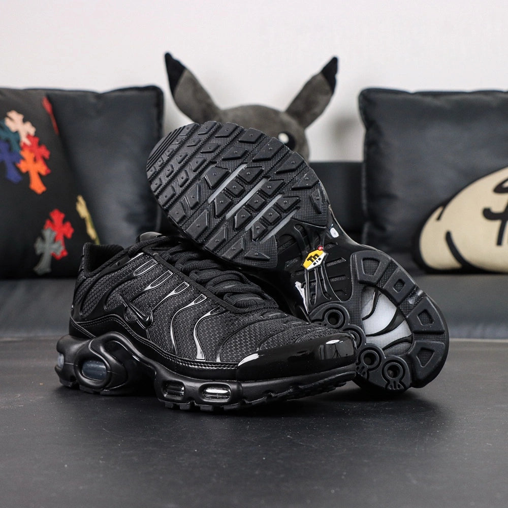 Air Max Plus Triple Black 2017 - Pair Top Down View on Dark Background Showing Gloss Black Wave Panels and Silver Air Badge