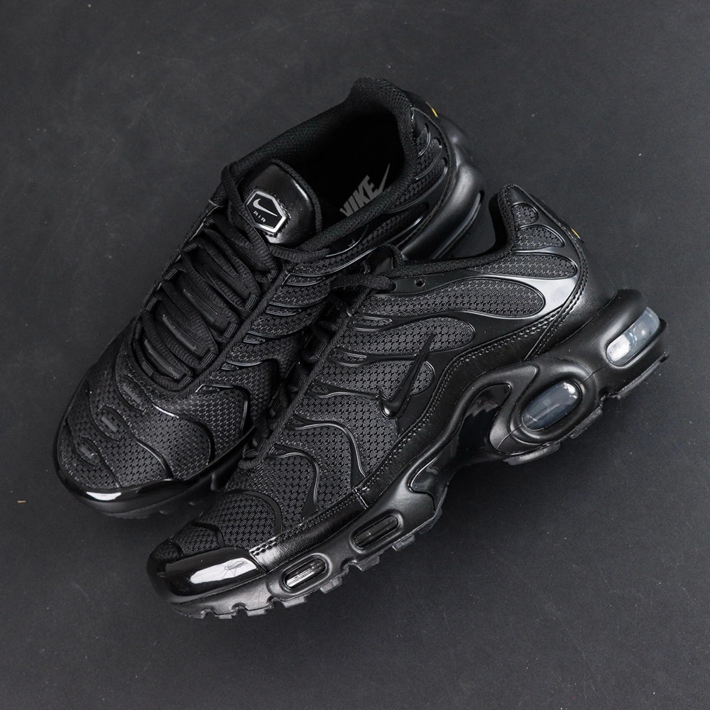 Air Max Plus Triple Black 2017 - Toe Box Close Up Detail Showing Gloss Black Patent Leather Wave Panels and Mesh on Dark Background