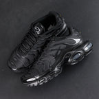 Air Max Plus Triple Black 2017 - Toe Box Close Up Detail Showing Gloss Black Patent Leather Wave Panels and Mesh on Dark Background