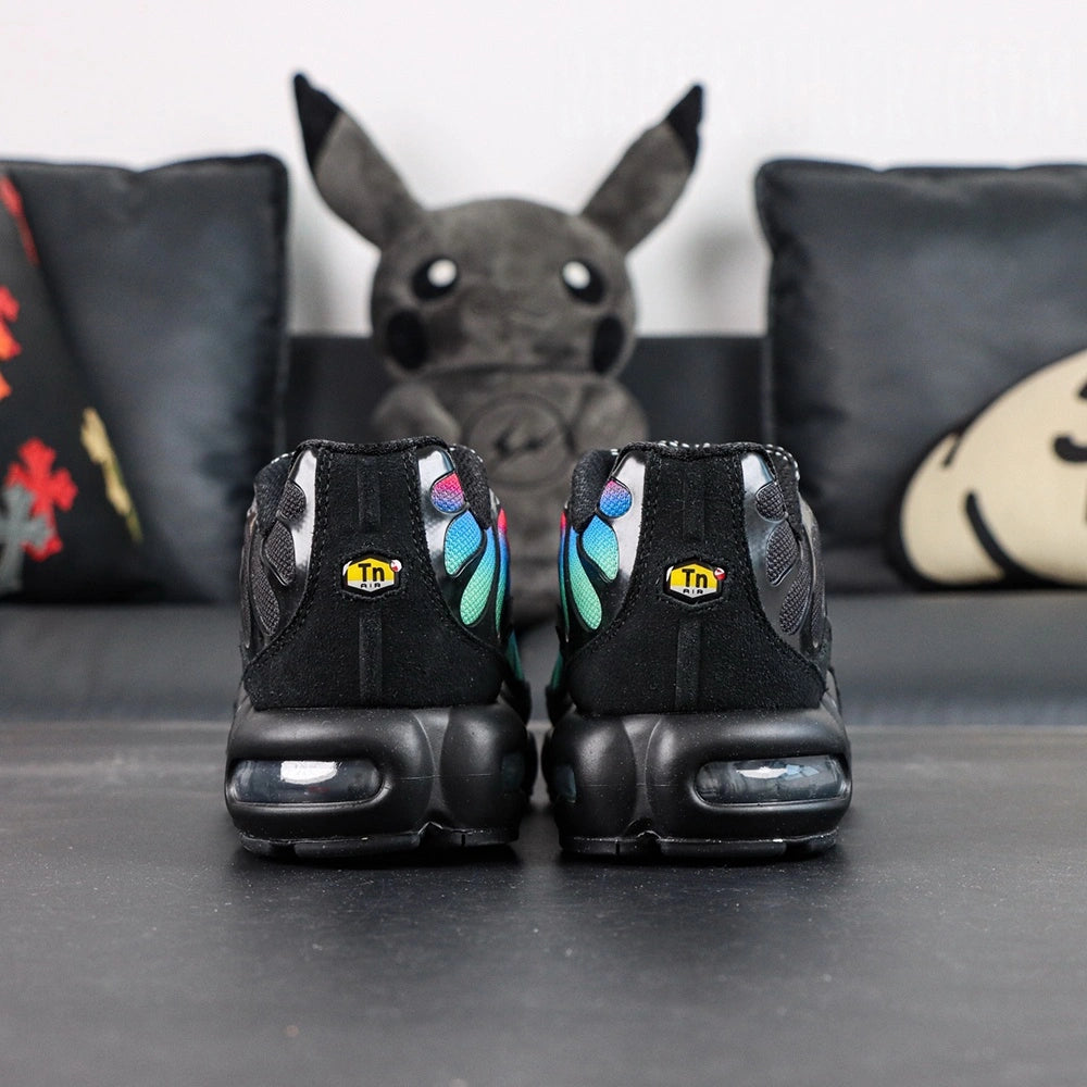 Air Max Plus Unity - Medial Side View with Pikachu on Sofa Showing Black Mesh and Tonal Black Wave Panels
