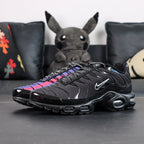 Air Max Plus Unity - Heel Pair Rear View with Yellow Tn Air Badge and Pikachu on Sofa Showing Iridescent Heel Wave Panels
