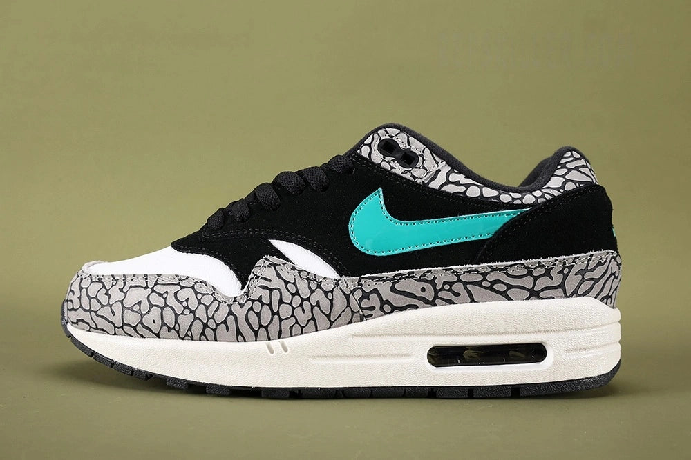 Atmos x Air Max 1 Premium Retro Elephant 2017 - Heel Pair Rear View Showing Teal Nike Air Embroidery and Grey Elephant Print Collar on Sage Background