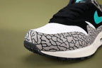 Atmos x Air Max 1 Premium Retro Elephant 2017 - Pair Rear View Showing Teal Nike Air Embroidery Yellow Tn Air Badge and Grey Elephant Print Collar on Sage Background
