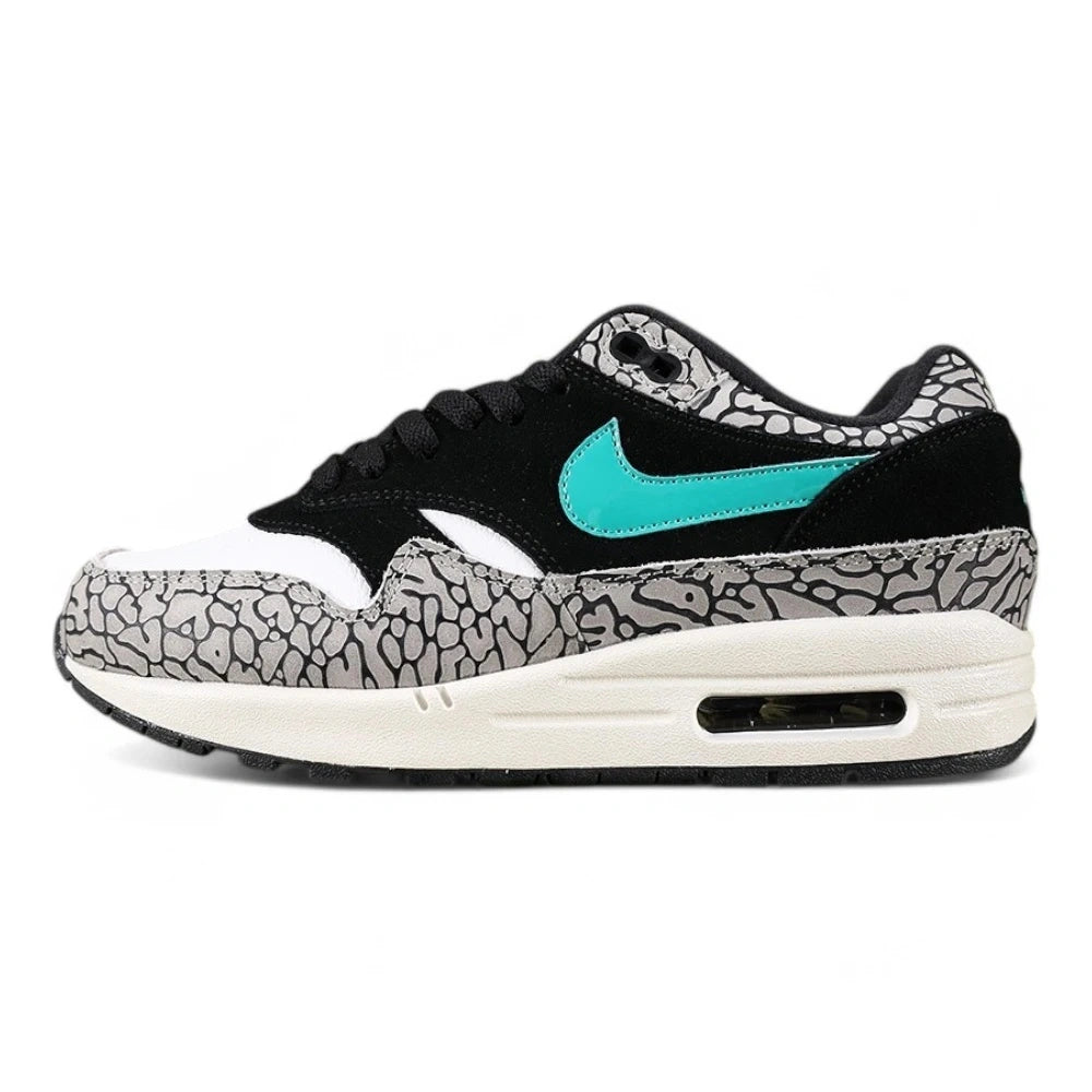Atmos x Air Max 1 Premium Retro Elephant 2017 - Three Quarter Lateral View Showing Grey Elephant Print Toe Box and Emerald Green Swoosh on Sage Background