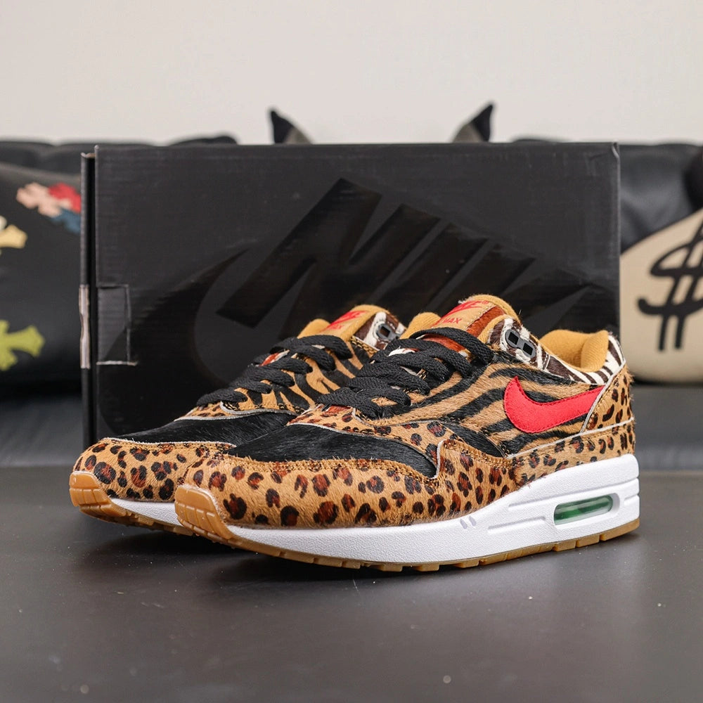 Atmos x Air Max 1 DLX Animal Pack 2018 - Toe Box Close Up Detail Showing Leopard Print Pony Hair and Black Zebra Stripe Quarter Panel on Dark Background