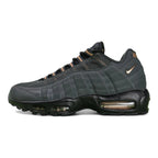 Central Cee x Air Max 95 Black and Gold - Lateral Side View Showing 3D Bronze Swoosh and Copper Heel Counter on Green Background