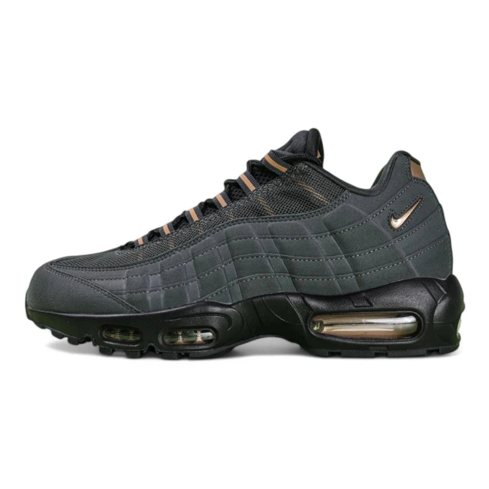Central Cee x Air Max 95 Black and Gold - Lateral Side View Showing 3D Bronze Swoosh and Copper Heel Counter on Green Background