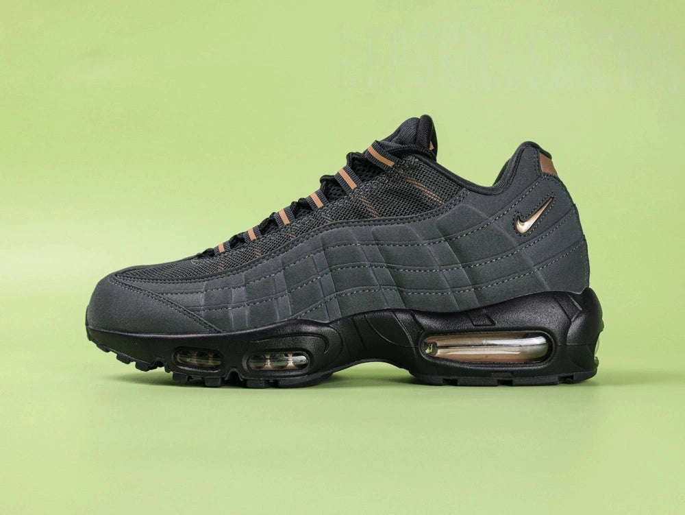 Central Cee x Air Max 95 Black and Gold - Full Outsole View Showing Black Waffle Tread and Gold 25 PSI Air Unit with Nike Swoosh Graphic on Green Background