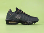 Central Cee x Air Max 95 Black and Gold - Forefoot Top Down Detail Showing Black Mesh Upper and Bronze Lace Dubraes on Green Background