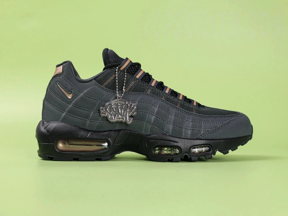 Central Cee x Air Max 95 Black and Gold - Forefoot Top Down Detail Showing Black Mesh Upper and Bronze Lace Dubraes on Green Background