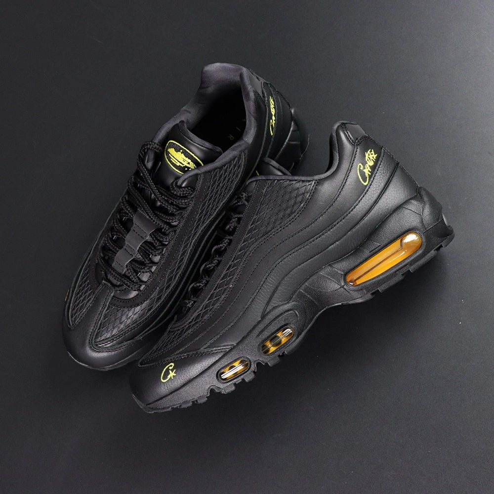 Corteiz x Air Max 95 SP Honey Blacks - Pair Top Down View on Dark Background Showing Diamond Quilted Texture Gold Corteiz Script and Oval Alcatraz Tongue Badge