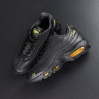 Corteiz x Air Max 95 SP Honey Blacks - Pair Top Down View on Dark Background Showing Diamond Quilted Texture Gold Corteiz Script and Oval Alcatraz Tongue Badge