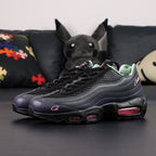 Corteiz x Air Max 95 SP Rules the World Pink Beam - Lateral Side View with Pikachu on Sofa Showing Hot Pink Swoosh and Corteiz Script on Black Leather Upper