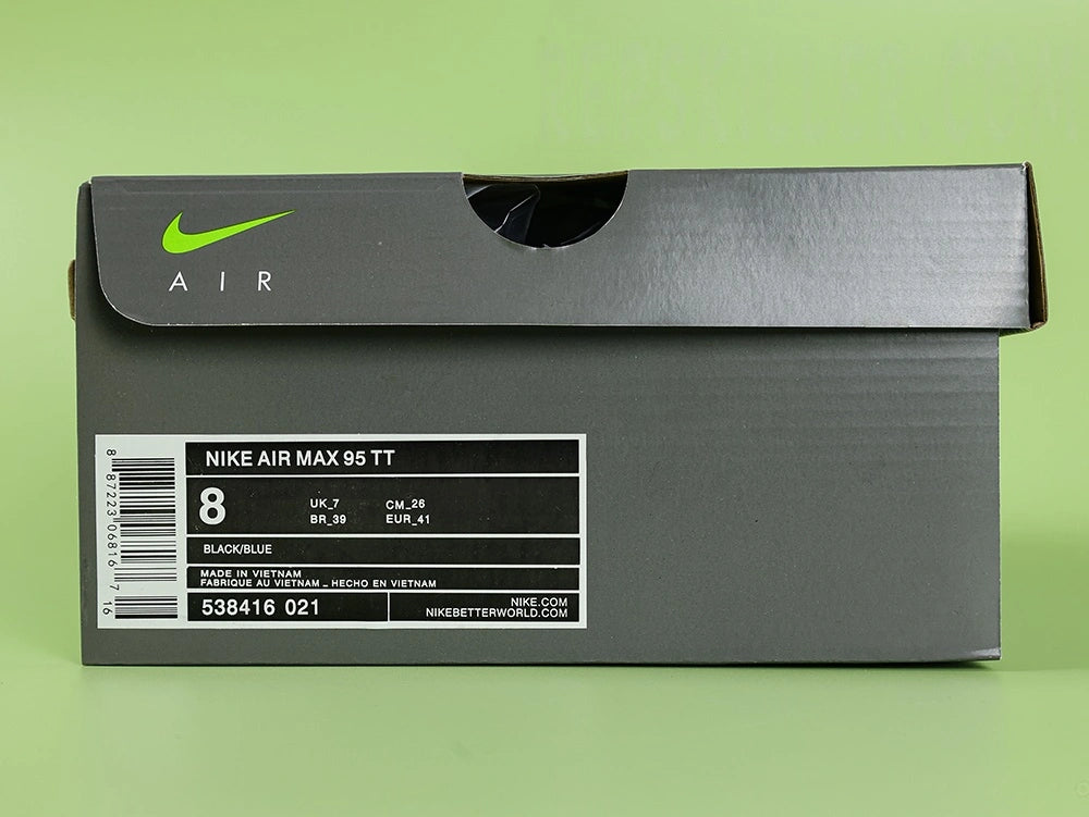 Air Max 95 TT Iridescent - Outsole View on Green Background Showing Black Waffle Tread Rubber Outsole and Orange Airmax Script on Lateral Midsole Wall with Burgundy Air Units