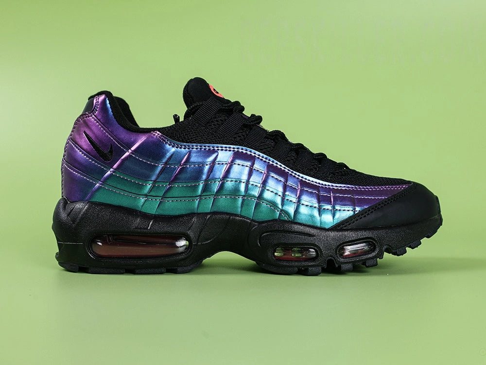 Air Max 95 TT Iridescent - Medial Toe Box Close Up on Green Background Showing Black Leather Mudguard Black Mesh Quarter Panel and Iridescent Blue Teal Spine Panel