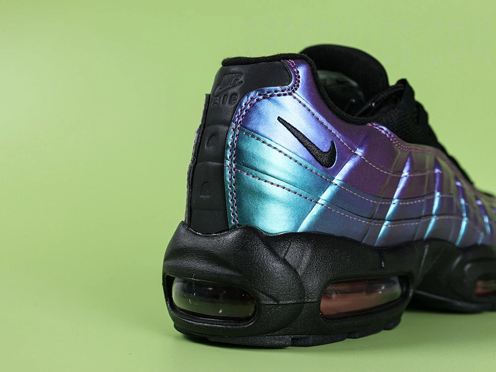 Air Max 95 TT Iridescent - Tongue Close Up on Green Background Showing Orange Embroidered Oval Airmax Badge on Black Tongue