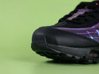 Air Max 95 TT Iridescent - Lateral Heel Spine Close Up on Dark Background Showing Iridescent Purple Blue Teal Chameleon Fabric with Black Embroidered Swoosh