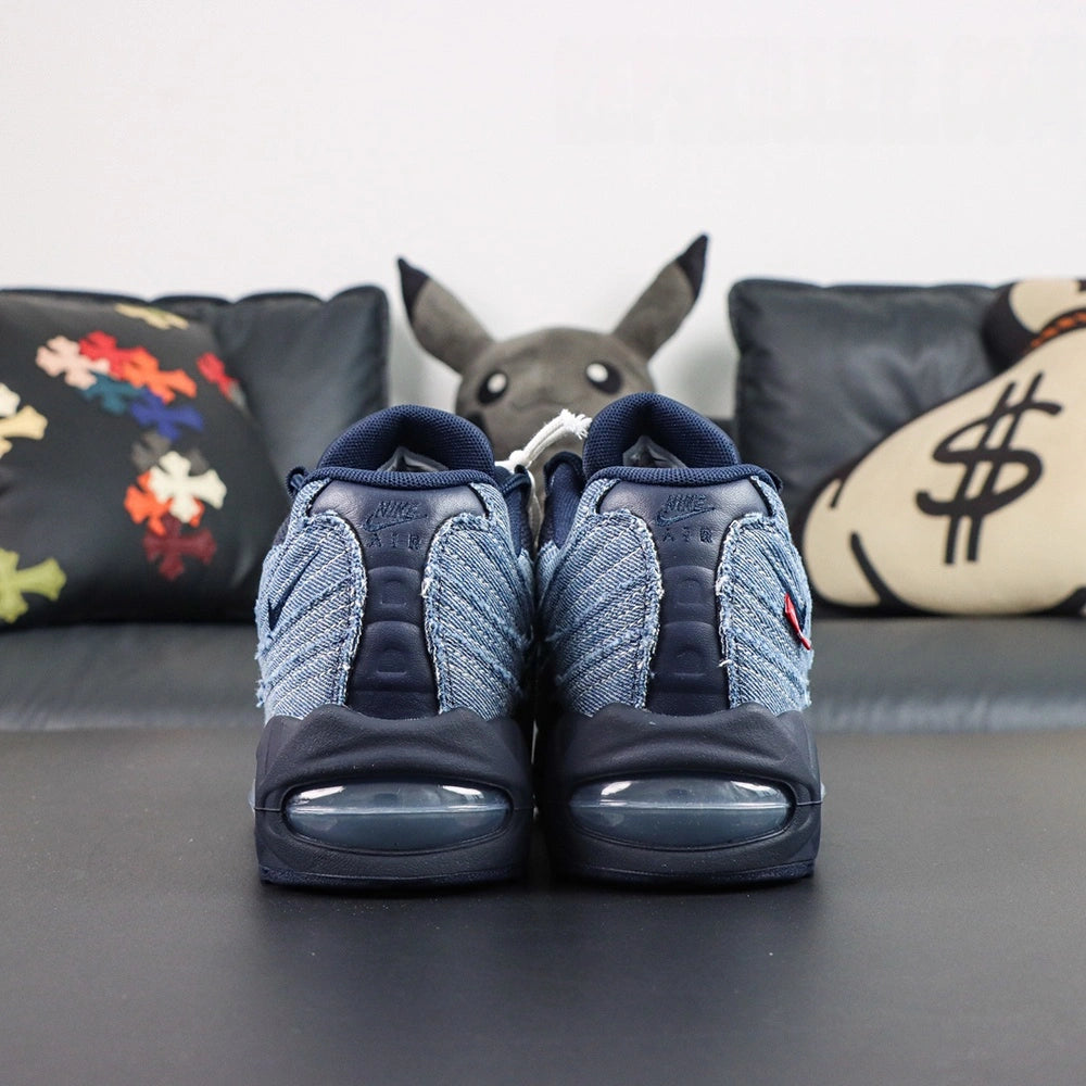 Levis x Air Max 95 OG Obsidian 2025 - Tongue Close Up Showing Oval Airmax Badge in Navy on Indigo and Levis Red Tab Label on Dark Background