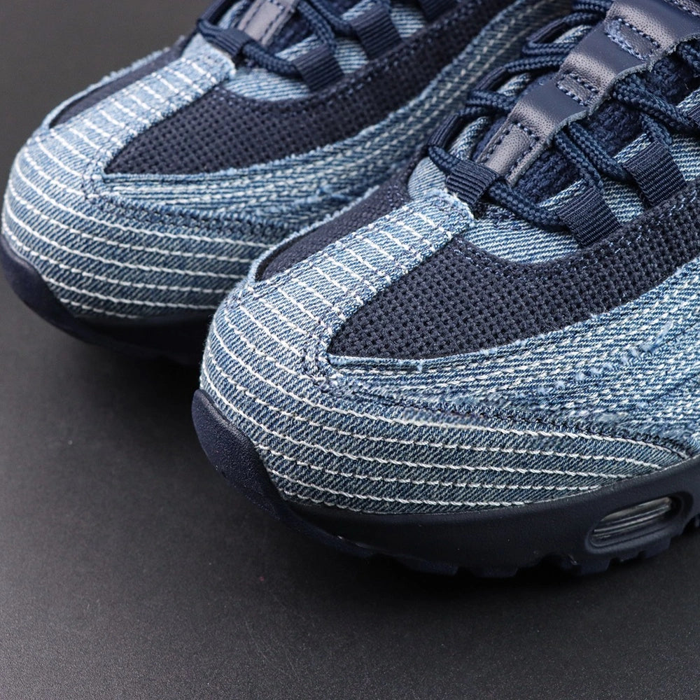 Levis x Air Max 95 OG Obsidian 2025 - Outsole View Showing Full Red Levis Branded Insole with White Levis Wordmark and Black Rubber Outsole on Dark Background