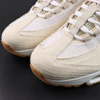 Levis x Air Max 95 OG Light Orewood Brown 2025 - Lateral Side View with Pikachu on Sofa Showing Full Cream Denim Upper Tonal Swoosh and Gum Rubber Outsole