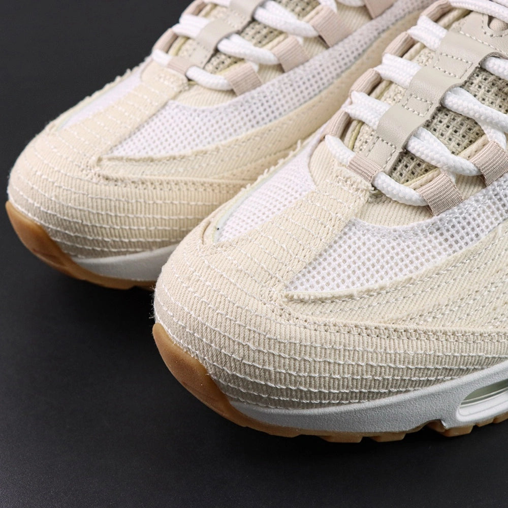 Levis x Air Max 95 OG Light Orewood Brown 2025 - Lateral Side View with Pikachu on Sofa Showing Full Cream Denim Upper Tonal Swoosh and Gum Rubber Outsole