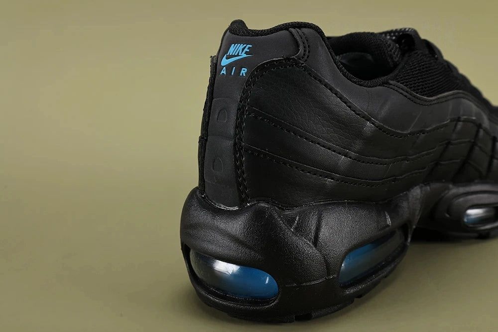 Nike Air Max 95 TT Black Laser Blue DZ4511-001 - Pair Three Quarter Lateral View on Olive Background Showing Full Black Upper Laser Blue Swoosh and Dark Navy Air Units