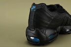 Nike Air Max 95 TT Black Laser Blue DZ4511-001 - Pair Three Quarter Lateral View on Olive Background Showing Full Black Upper Laser Blue Swoosh and Dark Navy Air Units