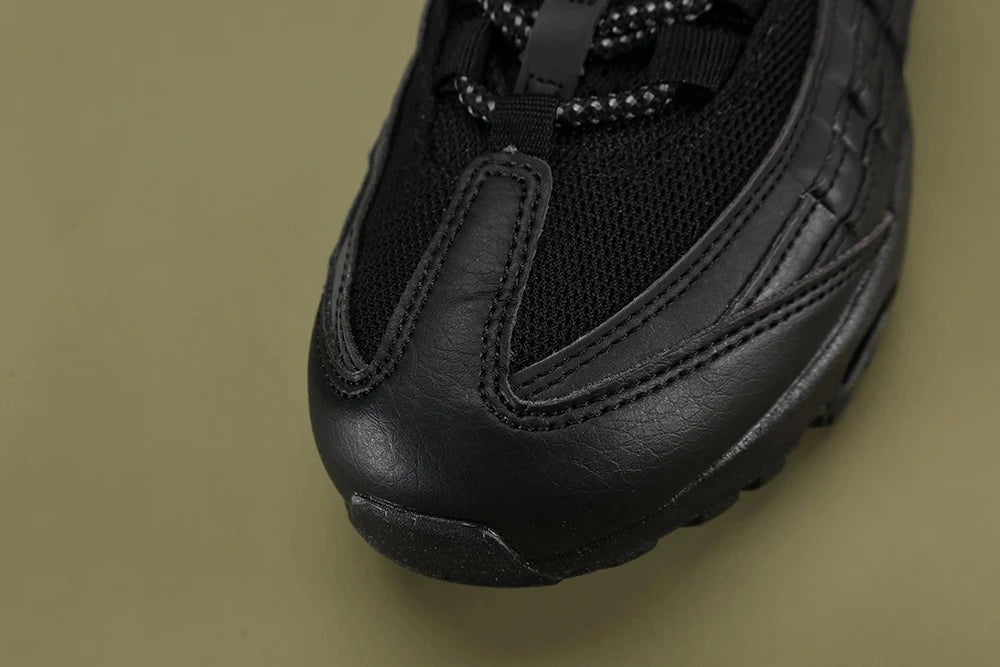 Nike Air Max 95 TT Black Laser Blue DZ4511-001 - Pair Heel Rear View on Olive Background Showing Laser Blue Nike Air Heel Counter Text and Dark Navy Translucent Air Units
