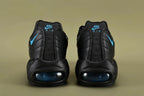 Nike Air Max 95 TT Black Laser Blue DZ4511-001 - Toe Box Close Up on Olive Background Showing Black Tumbled Leather Texture and Black Engineered Mesh Quarter Panel