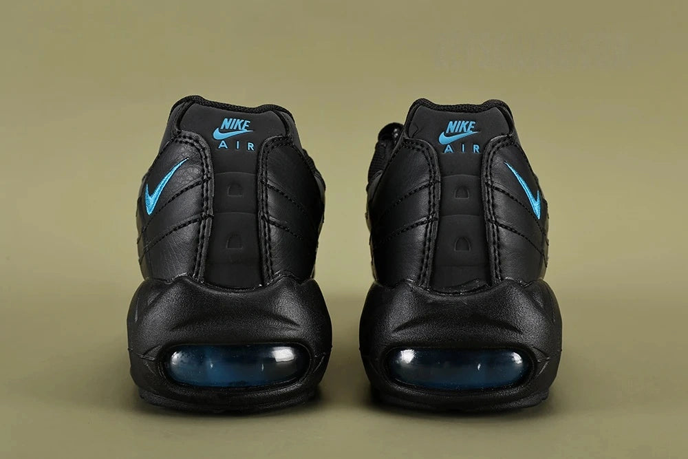 Nike Air Max 95 TT Black Laser Blue DZ4511-001 - Toe Box Close Up on Olive Background Showing Black Tumbled Leather Texture and Black Engineered Mesh Quarter Panel