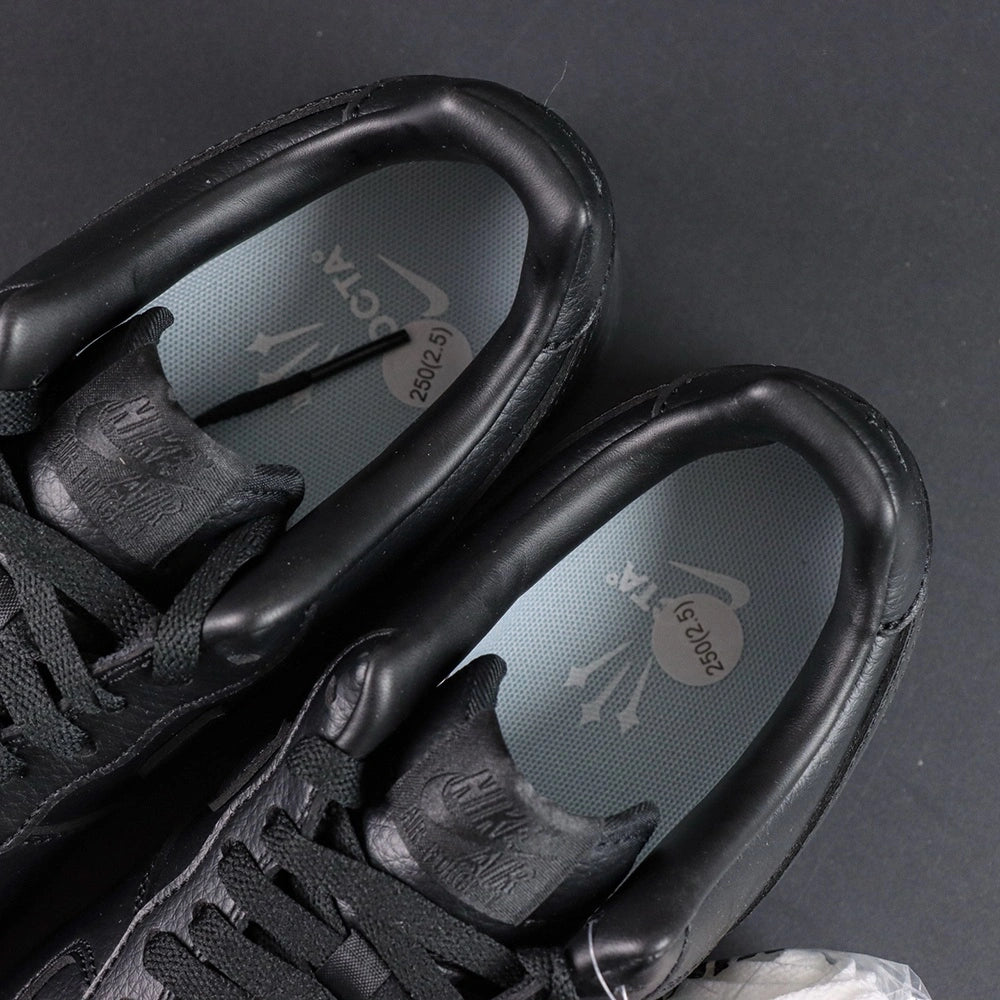 NOCTA x Air Force 1 Low Certified Lover Boy Black - pair overhead flat lay Love you forever midsole