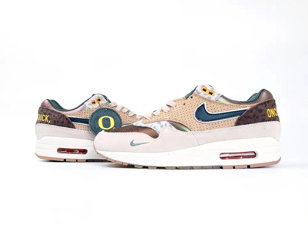 Air Max 1 87 Premium PE University of Oregon - Medial Side View on White Background Showing Perforated Tan Leather Teal Mini Swoosh on Suede and Once A Duck Yellow Embroidered Heel Text
