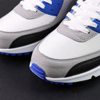 Air Max 90 Hyper Royal 2020 - Pair Three Quarter Lateral View on Dark Background Showing White Leather Toe Box Grey Suede Quarter Panel Black Mudguard Hyper Royal Blue Corduroy Rear Panel and Grey Tonal Swoosh