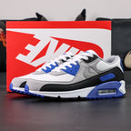 Air Max 90 Hyper Royal 2020 - Pair Heel Rear View with Pikachu on Sofa Showing Hyper Royal Blue Ribbed Heel Badge with Black Air Text and Black Swoosh