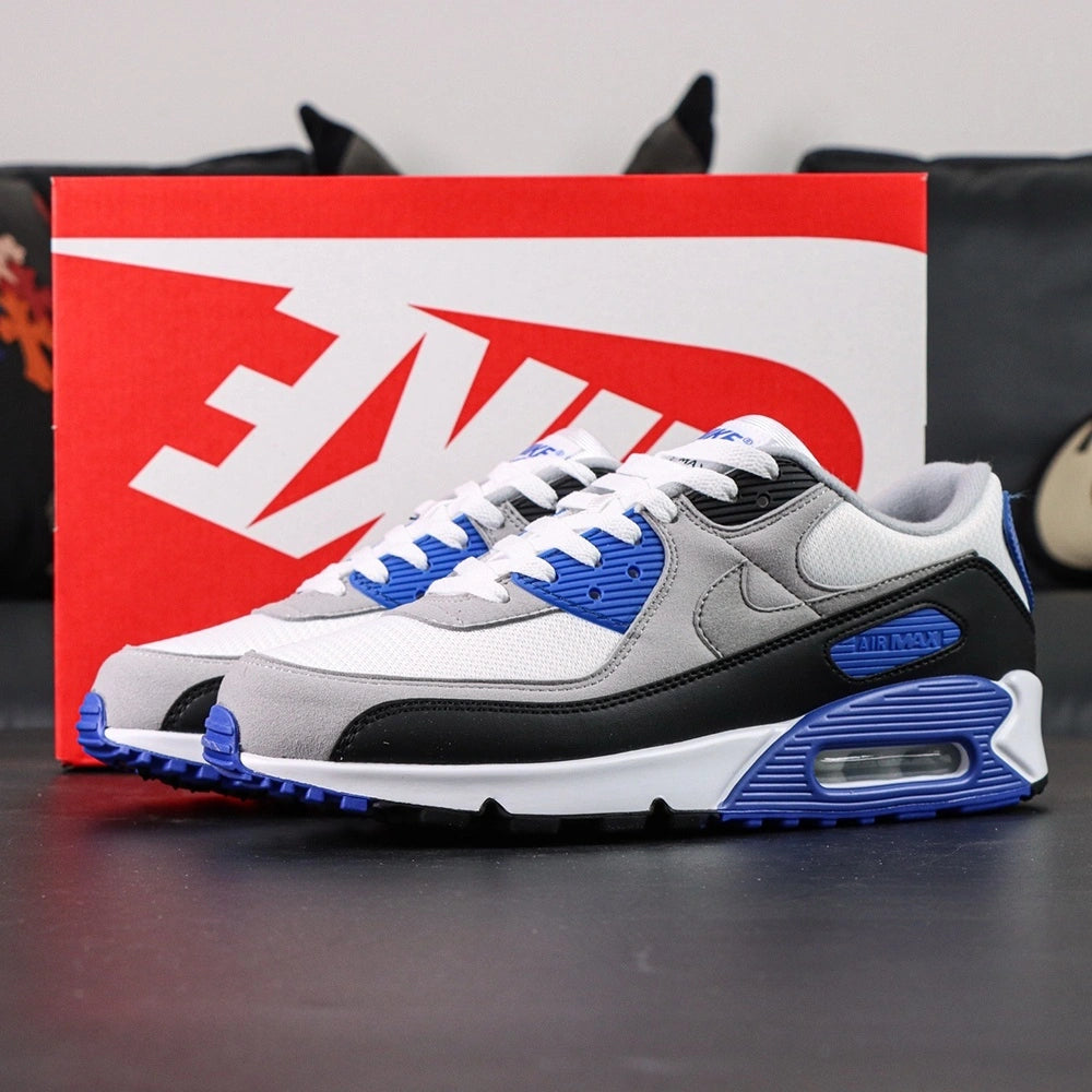 Air Max 90 Hyper Royal 2020 - Pair Heel Rear View with Pikachu on Sofa Showing Hyper Royal Blue Ribbed Heel Badge with Black Air Text and Black Swoosh