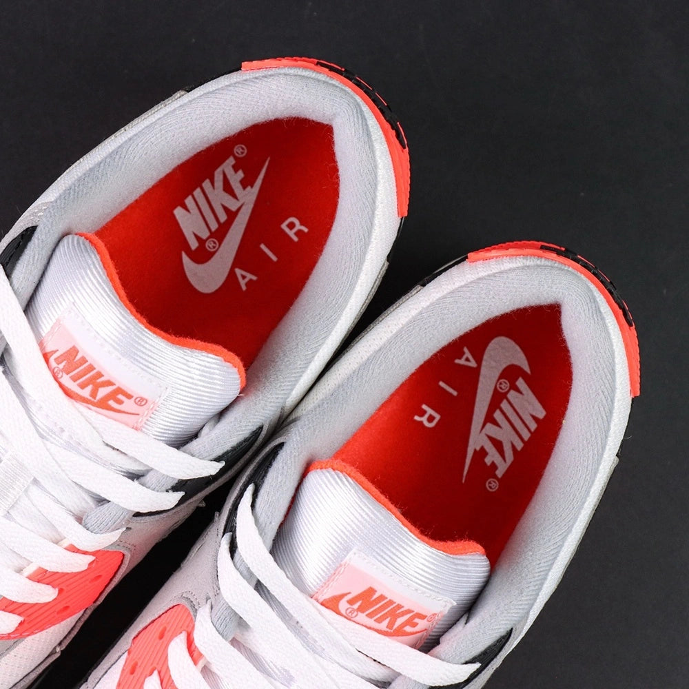 Air Max 90 Infrared 2020 - Pair Heel Rear View with Pikachu on Sofa Showing Infrared Red Ribbed Corduroy Heel Badge with Black Air Text and Black Swoosh on Both Shoes