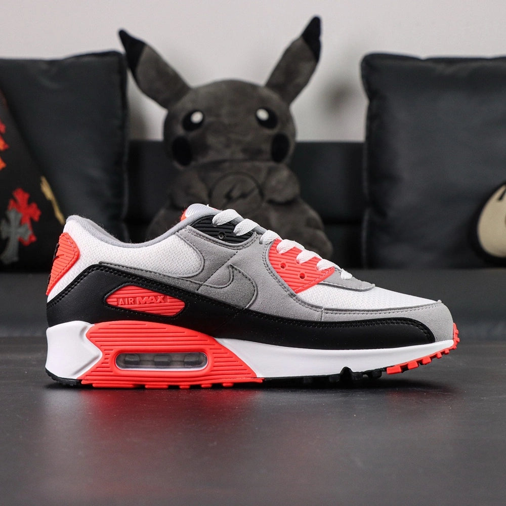 Air Max 90 Infrared 2020 - Pair Three Quarter Lateral View with Red Shoebox on Dark Background Showing Full Upper Construction and Infrared Red Midsole Accents