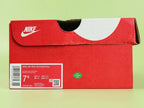 Air Max 95 Essential Triple Black - Pair Three Quarter Lateral View on Green Background Showing Full Tonal Black Construction Black Rope Laces and Black Midsole