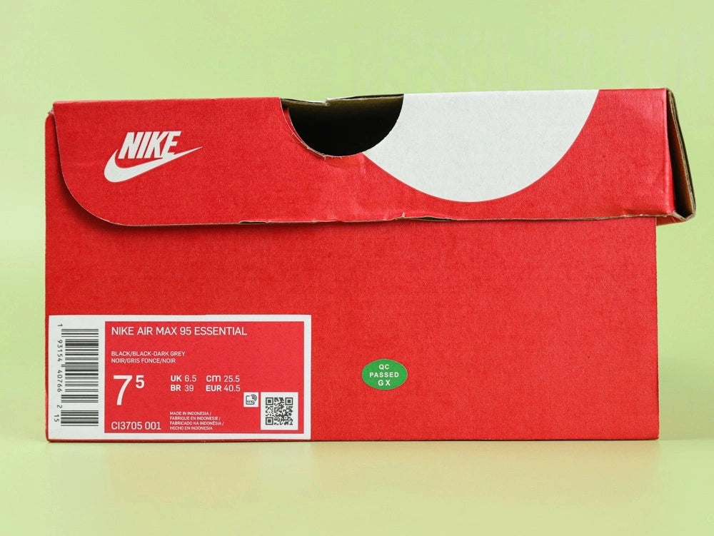 Air Max 95 Essential Triple Black - Pair Three Quarter Lateral View on Green Background Showing Full Tonal Black Construction Black Rope Laces and Black Midsole