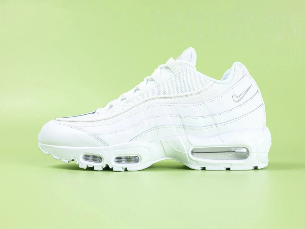 Air Max 95 Essential White Grey Fog - Outsole View on Green Background Showing Full White Rubber AM95 Square Block Waffle Tread with Central Translucent Window