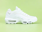 Air Max 95 Essential White Grey Fog - Tongue Close Up on Green Background Showing Silver Grey Embroidered Oval Airmax Badge on Pale Ice Blue White Mesh Tongue