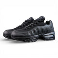 Air Max 95 OG Black Anthracite 2025 - Pair Heel Close Up with Pikachu on Sofa Showing Tonal Black Anthracite Heel Badge with Air Text Swoosh and Translucent Smoke Blue Air Units
