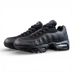 Air Max 95 OG Black Anthracite 2025 - Pair Heel Close Up with Pikachu on Sofa Showing Tonal Black Anthracite Heel Badge with Air Text Swoosh and Translucent Smoke Blue Air Units