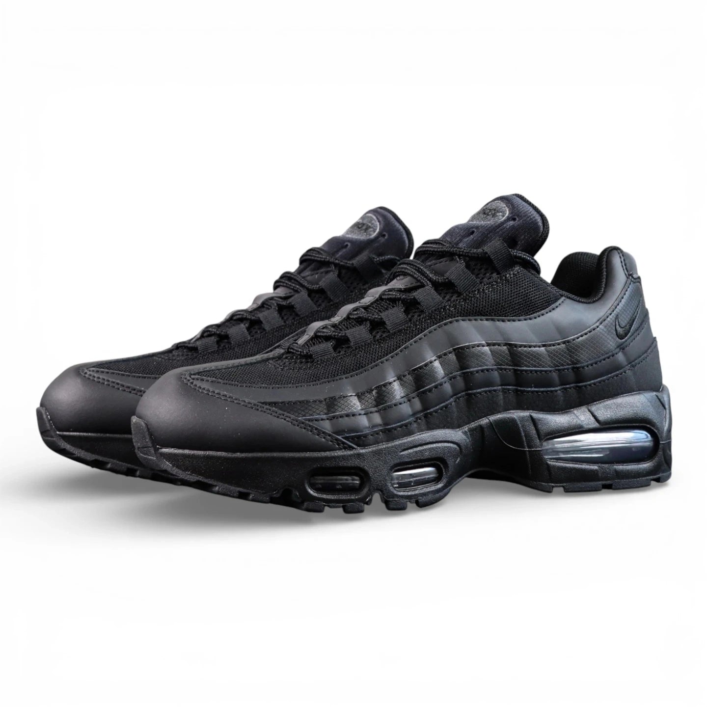Air Max 95 OG Black Anthracite 2025 - Pair Heel Close Up with Pikachu on Sofa Showing Tonal Black Anthracite Heel Badge with Air Text Swoosh and Translucent Smoke Blue Air Units